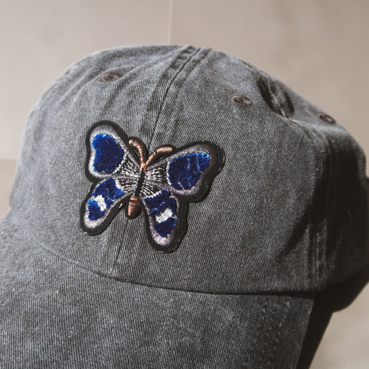 The Butterfly Baseball Cap is an essential washed cotton-twill baseball cap in vintage black. The perfect hat to elevate any casual look, whether running for coffee or any everyday adventure. #baseballcapforwomen #butterflybaseballcap #blackbaseballcap #womenbaseballcap #womenhat #butterflyhat