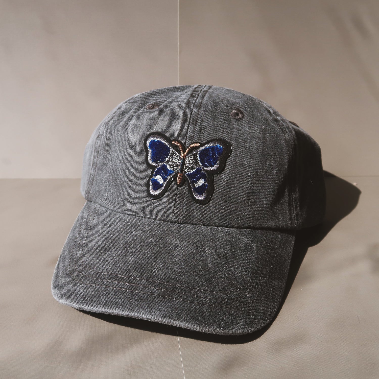 The Butterfly Baseball Cap is an essential washed cotton-twill baseball cap in vintage black. The perfect hat to elevate any casual look, whether running for coffee or any everyday adventure. #baseballcapforwomen #butterflybaseballcap #blackbaseballcap #womenbaseballcap #womenhat #butterflyhat